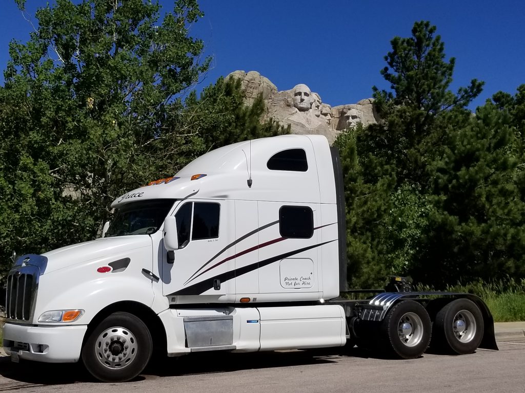 Our Peterbilt semi truck sits in front of the four faces of Mt. Rushmore.